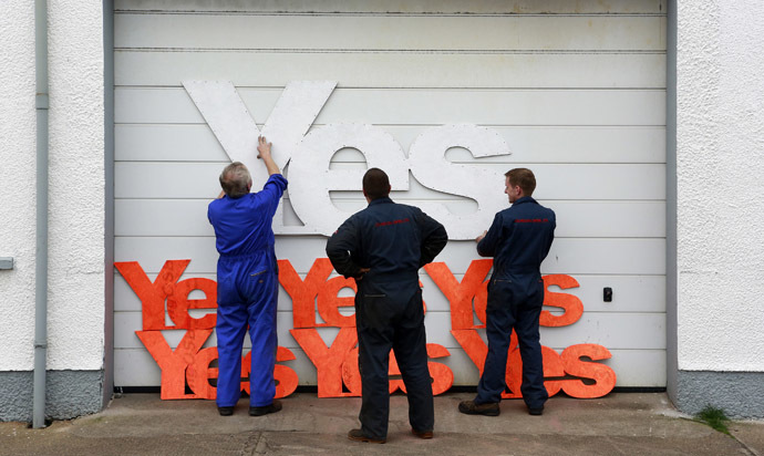 Employees of Gordon diesel services prepare to erect Yes campaign placards on their workshop in Stornoway on the Isle of Lewis in the Outer Hebrides September 11, 2014. (Reuters/Cathal McNaughton)