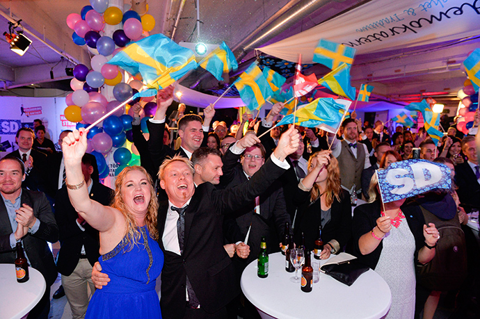 People celebrate at the election night party of the Sweden Democrats, after first exit polls indicated that the party will be the third largest in the Swedish parliament after the Swedish general elections, in Stockholm, September 14, 2014 (Reuters / Anders Wiklund)