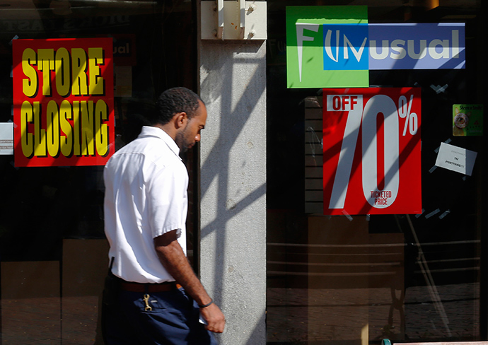 A man walks past a "Store Closing" sign in a shop window at Quincy Market in Boston, Massachusetts September 5, 2014 (Reuters / Brian Snyder)