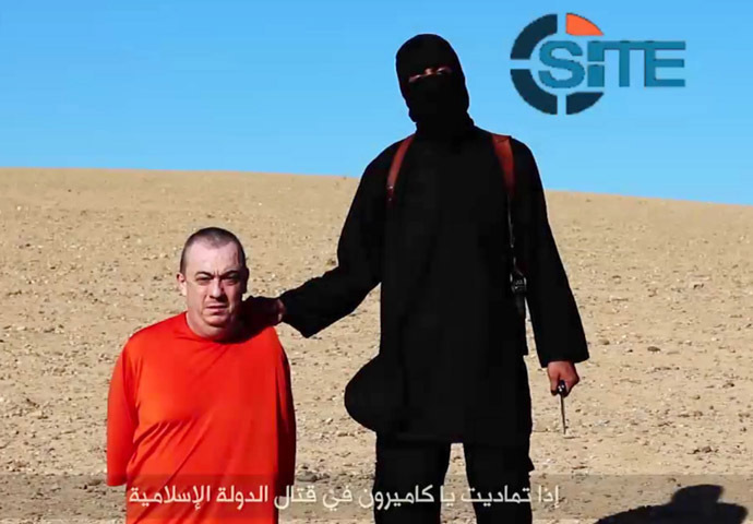 In a still taken from an IS video, uploaded to the web on Saturday, a masked jihadist warns UK hostage Alan Henning will be the terror group's next victim.(AFP Photo / Site Intelligence Group)