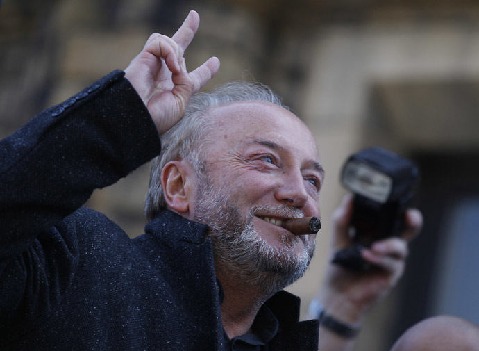 Respect Party candidate George Galloway gestures from an open top bus outside his campaign office in Bradford, northern England, March 30, 2012.(Reuters/Darren Staples)