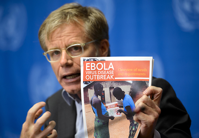 World Health Organization's Assistant Director General Bruce Aylward holds a report on Ebola virus during a press conference on global aid pledged to fight the Ebola outbreak in west Africa on September 16, 2014 at United Nations offices in Geneva. (AFP Photo / Fabrice Coffrini)
