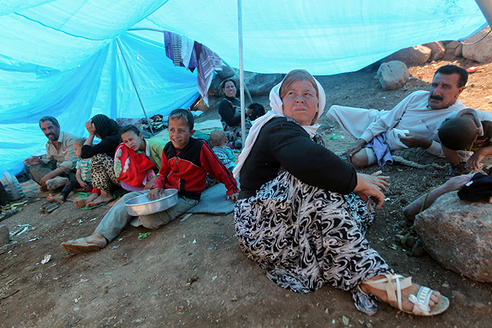 An Iraqi Yazidi refugee family gathers under a tent at Newroz camp in Hasaka province, north eastern Syria after fleeing Islamic State militants in Iraq. (AFP Photo / Ahmad Al-Rubaye)