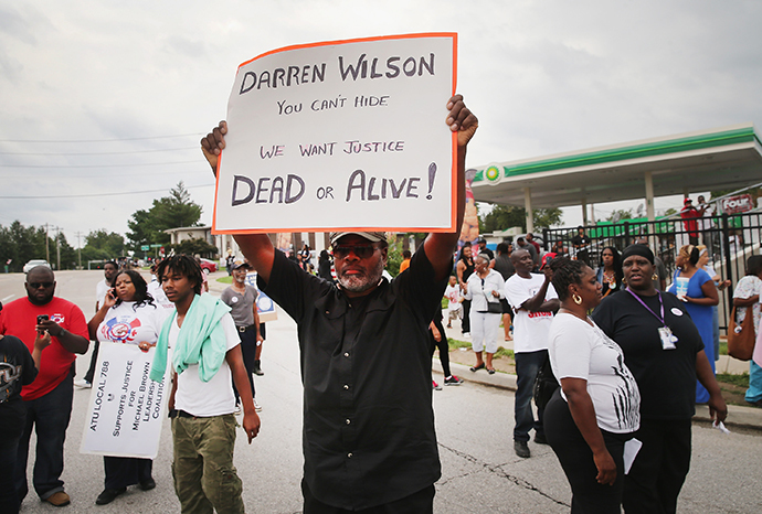 Demonstrators protest near a ramp which leads onto Interstate Highway 70 near Ferguson, Missouri. (Scott Olson / Getty Images / AFP)