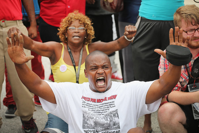 Demonstrators sit in the street after police prevented them from gaining access to Interstate Highway 70 near Ferguson, Missouri. (Scott Olson / Getty Images / AFP)