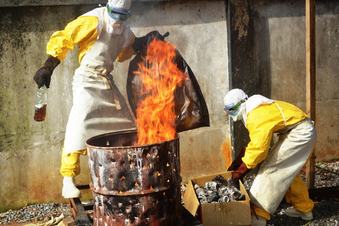 Health worker burn used protection gear at the NGO Medecins Sans Frontieres (Doctors Without Borders) center in Conakry on September 13, 2014.(AFP Photo / Cellou Binani)
