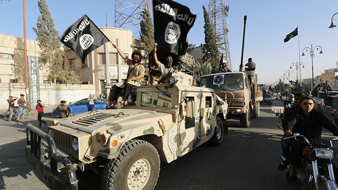 Militant Islamist fighters take part in a military parade along the streets of Syria's northern Raqqa province (Reuters)