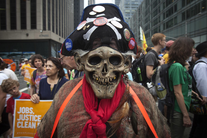 A protester in a skull mask takes part in the "People's Climate March" down 6th Ave in the Manhattan borough of New York September 21, 2014. (Reuters/Carlo Allegri)
