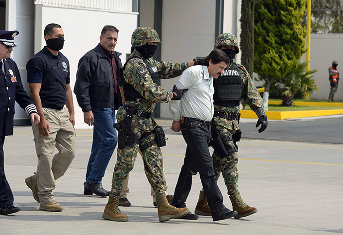 Mexican drug trafficker Joaquin Guzman Loera aka "el Chapo Guzman" (2-R), is escorted by marines as he is presented to the press on February 22, 2014 in Mexico City. (AFP Photo / Alfredo Estrella)