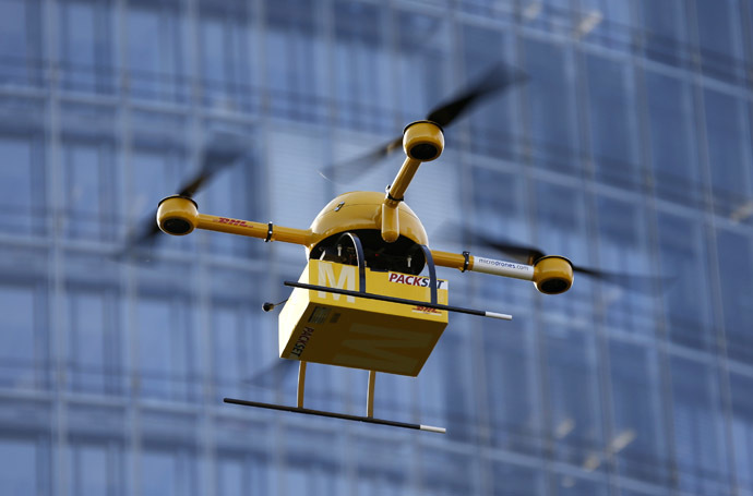 A prototype "parcelcopter" of German postal and logistics group Deutsche Post DHL flies in front of the company's headquarters in Bonn December 9, 2013. (Reuters/Wolfgang Rattay)