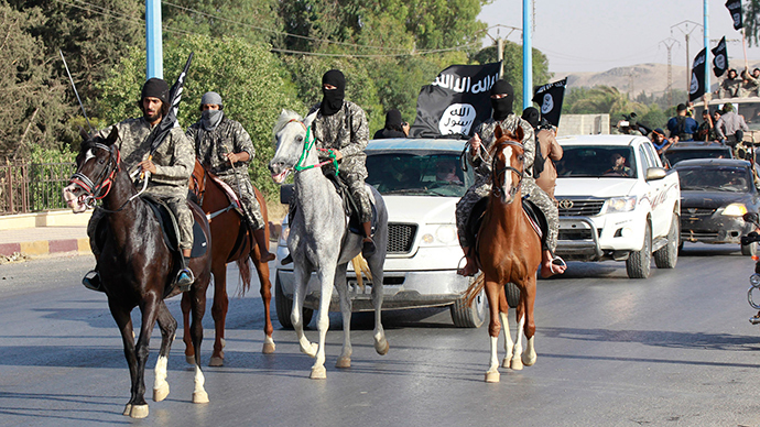 Militant Islamist fighters ride horses as they take part in a military parade along the streets of Syria's northern Raqqa province (Reuters / Stringer)