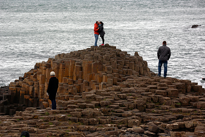 A couple embrace on the rocks at the Giant's Causeway situated on the north coast of Northern Ireland (Reuters / Cathal McNaughton)