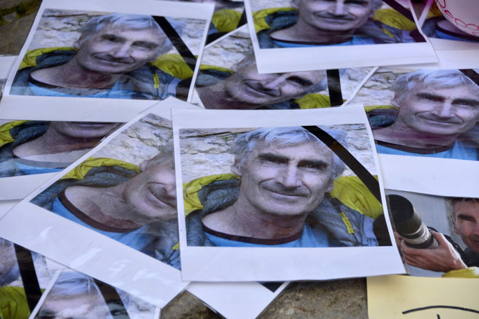 Portraits of mountain guide Frenchman Herve Gourdelin are seen as people pay tribute in Saint-Martin-Vesubie, September 25, 2014. (Reuters/Patrice Masante)