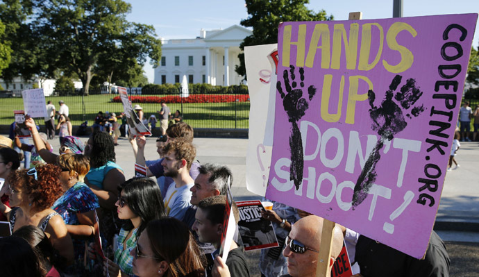 Protesters march as they call for a thorough investigation of the shooting death of teen Michael Brown in Ferguson, Missouri, on a street in front of the White House in Washington (Reuters/Larry Downing)