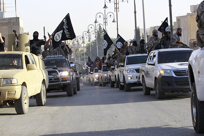 Militant Islamist fighters parade on military vehicles along the streets of northern Raqqa province (Reuters / Stringer) 