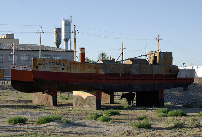 A cow takes shade in the shadow of a derelict boat in the former Aral Sea port of Aralsk, June 24, 2008 (Reuters / Aziz Mamirov) 