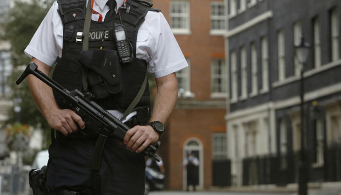 An armed police officer is seen on duty in Downing Street, central London September 1, 2014. (Reuters/Luke MacGregor)