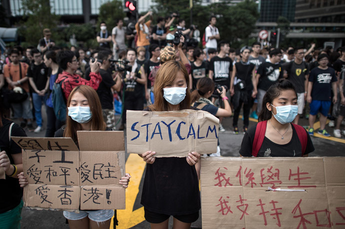 Demonstrators display placards as they gather near a ceremony marking China's 65th National Day in Hong Kong on October 1, 2014. (AFP Photo)
