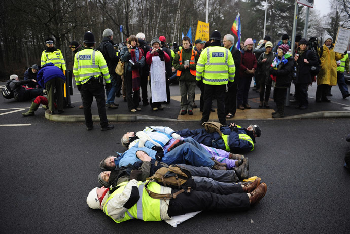 Anti-nuclear demonstrators lie in the road outside a gate of the Atomic Weapons establishment (AWE) at Aldermaston in southern England February 15, 2010. (Reuters/Kieran Doherty)