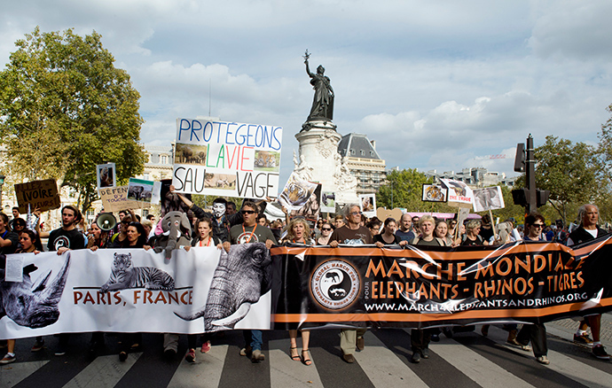 Protesters hold a sign reading "Let's protect wildlife" as they take part in a demonstration in Paris as part of the Global March for Elephants, Rhinos and Lions on October 4, 2014 (AFP Photo / Alain Jocard)