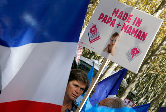 A demonstrator holds a placard as he takes part in a "Manif Pour Tous" (Demonstration For All) march to protest against PMA (Procreation Medicalement Assistee or Medically Assisted Reproduction) and GPA (Grosesse pour Autrui or Gestation for Others) in Bordeaux, Southwestern France, October 5, 2014 (Reuters / Regis Duvignau)