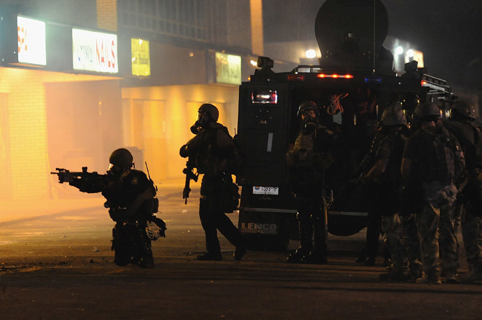 Police officers fire canisters of tear gas on protestors as they try to flee from West Florissant Road in Ferguson, Missouri (AFP Photo / Michael B. Thomas)