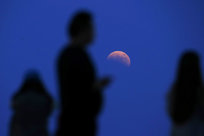The beginning of a total lunar eclipse is seen from the Qizhong Tennis Court in Shanghai October 8, 2014. (Reuters/Aly Song)