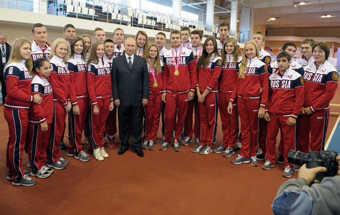 Russian President Vladimir Putin talks to the winners of the 2014 Summer Youth Olympics in Nanjing during a visit to Youth Olympic School No. 3 in Cheboksary on October 9, 2014. (RIA Novosti / Alexei Druzhinin) 