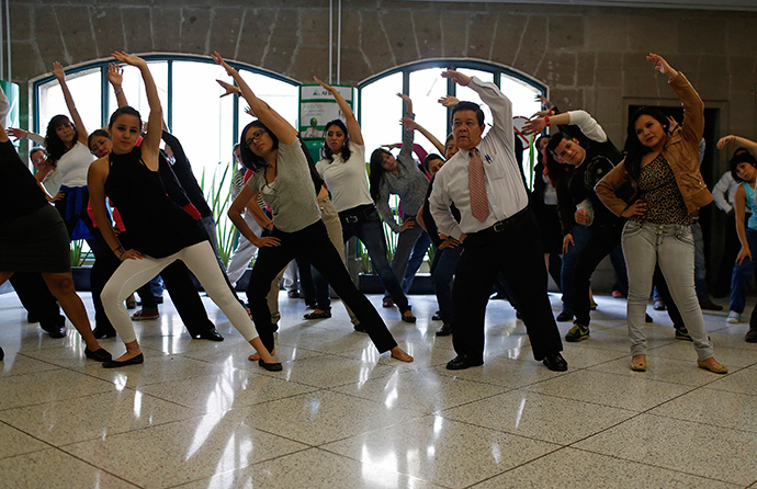 Local government employees participate in a mandatory physical activity session at their office in downtown Mexico City (Reuters)