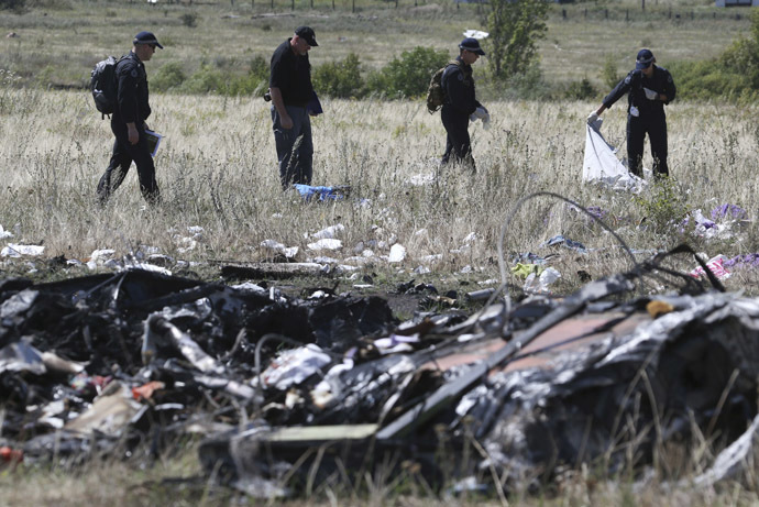 Members of a group of international experts inspect the territory at the site where the downed Malaysia Airlines flight MH17 crashed, near the village of Hrabove (Grabovo) in Donetsk region, eastern Ukraine August 1, 2014. (Reuters/Sergei Karpukhin)