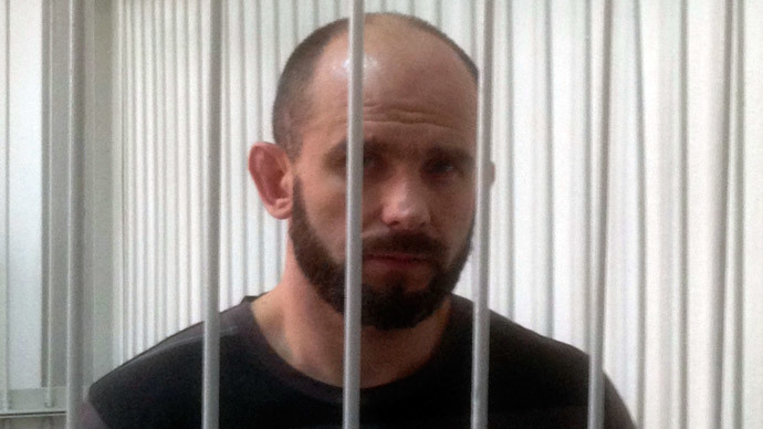 Ex-Berkut commander Dmytro Sadovnyk stands inside a metal cage during a court hearing in Kiev September 5, 2014. (Reuters / Steve Stecklow )