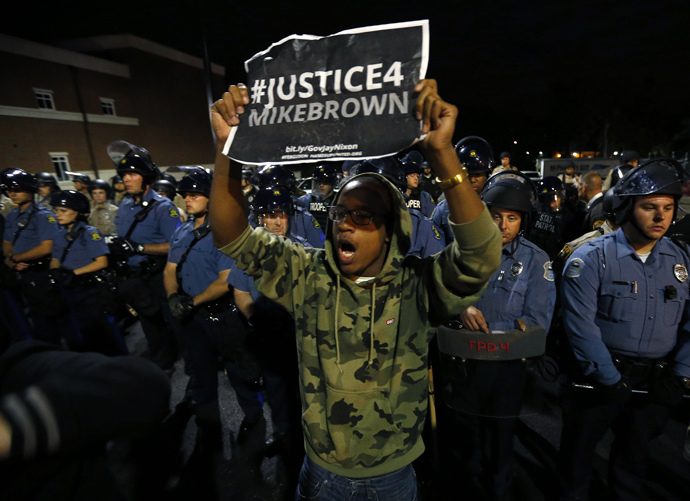 A protester demonstrates in front of a police line in Ferguson, Missouri October 10, 2014. (Reuters / Jim Young)