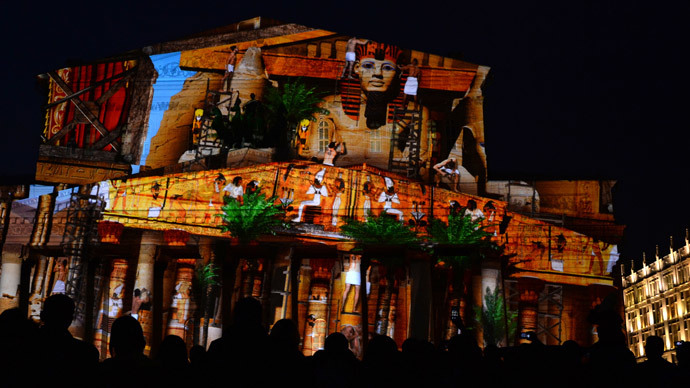 People watch a light show projected on the facade of the Bolshoi Theatre in Moscow on October 10, 2014, during the "Circle of Light" Moscow International Festival.(AFP Photo / Vasily Maximov)