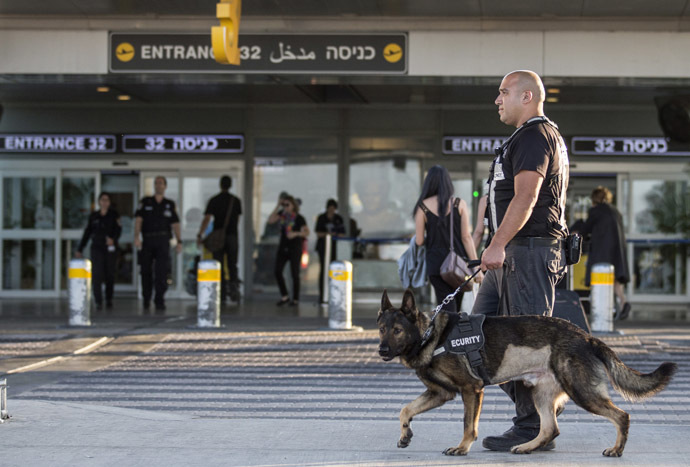 A security officer leads a dog as they patrol the entrance of Ben Gurion International airport. (AFP Photo/Jack Guez)