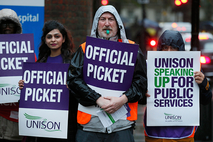 NHS workers hold placards during a strike, outside St Pancras Hospital in London October 13, 2014 (Reuters / Stefan Wermuth)