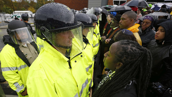 Protestors stand in front of the riot police during a protest at the Ferguson Police Department in Ferguson, Missouri, October 13, 2014. (Reuters/Jim Young)