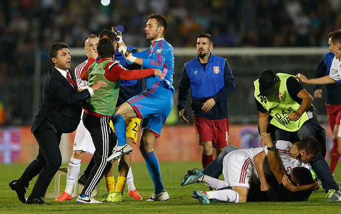Fans and players of Serbia and Albania scuffle during their Euro 2016 Group I qualifying soccer match at the FK Partizan stadium in Belgrade October 14, 2014. (Reuters / Marko Djurica)