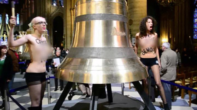 Femen strike bells and shout âPope no more!â and âClear off, homophobe!â. February, 2013. (Screenshot from RT report) 
