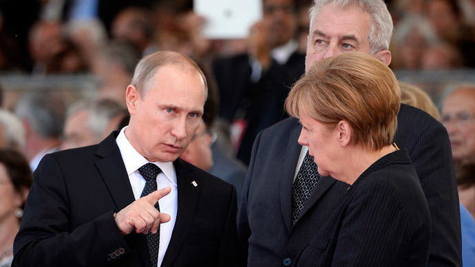 Russian President Vladimir Putin and German Chancellor Angela Merkel chat at the international D-Day commemoration ceremony in Normandy, on June 6, 2014.(AFP Photo / Alain Jocard)