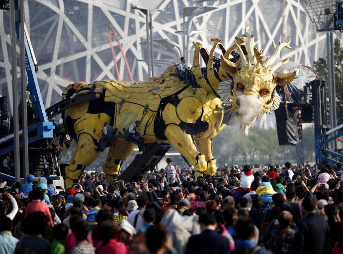 People watch a mechanical installation named "Long Ma" emit water vapour during the Long Ma performance in front of the National Stadium, also known as the Bird's Nest, in Beijing October 17. (Reuters/Kim Kyung-Hoon)