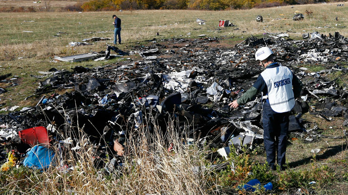 Members of the recovery team work at the site where the downed Malaysia Airlines flight MH17 crashed, near the village of Hrabove (Grabovo) in Donetsk region, eastern Ukraine, October 13, 2014. (Reuters / Shamil Zhumatov)
