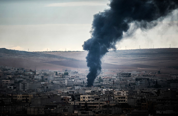 Smoke rises from the Syrian town of Kobani, also known as Ain al-Arab, as it is seen from the southeastern village of Mursitpinar, Sanliurfa province, on October 19, 2014. (AFP Photo / Bulent Kilic)