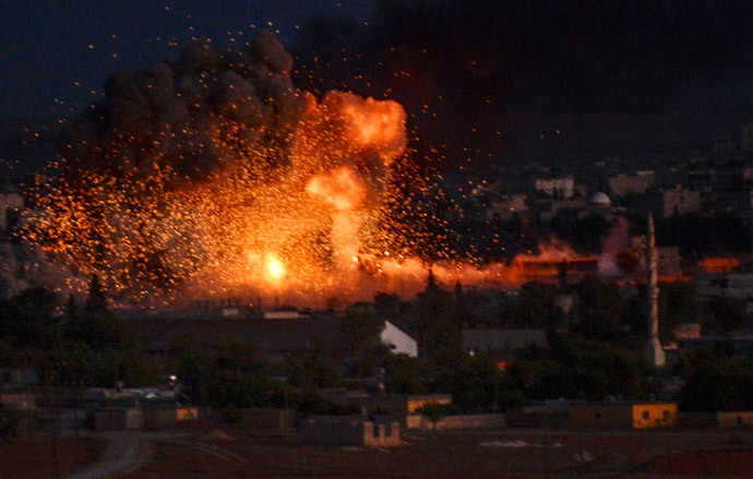 Flames rise following an explosion in the Syrian town of Kobani, also known as Ain al-Arab, as seen from the southeastern Turkish village of Mursitpinar in the Sanliurfa province on October 20, 2014. (AFP Photo / Bulent Kilic)