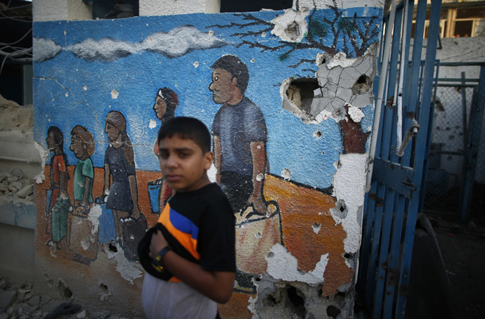 A Palestinian boy looks on as he stands at a United Nations-run school sheltering Palestinians in the northern Gaza Strip July 30, 2014. (Reuters/Mohammed Salem)