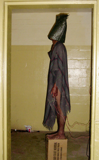 This handout photo from SBS TV received 15 February, 2006 shows a hooded prisoner allegedly being tortured at Iraq's notorious Abu Ghraib jail supposely during interrogation by US soldiers in Baghdad in 2004. (AFP Photo/HO/SBS Dateline)