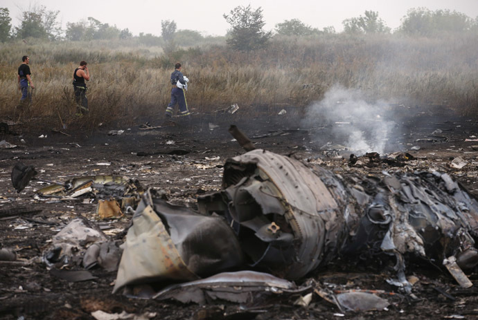 Emergencies Ministry members walk at the site of a Malaysia Airlines Boeing 777 plane crash, MH17, near the settlement of Grabovo in the Donetsk region, July 17, 2014. (Reuters/Maxim Zmeyev)