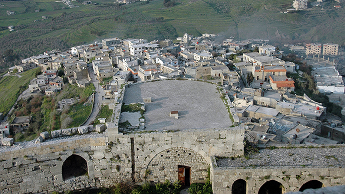 A handout picture released by the official Syrian Arab News Agency (SANA) on March 21, 2014, shows a general view of part of the Krak de Chevaliers castle overlooking al-Hosn village in the Homs region, about 200 kms northwest of the capital Damascus (AFP Photo / SANA)