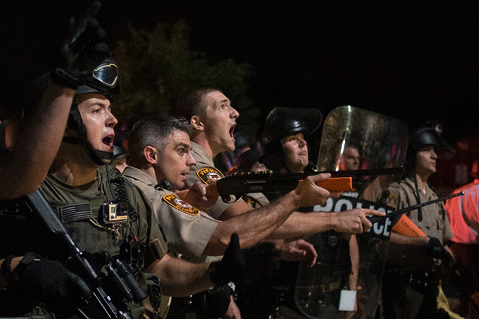 Security forces charge demonstrators after being hit by water bottles during a protest against the shooting of unarmed black teen Michael Brown in Ferguson, Missouri August 20, 2014 (Reuters / Adrees Latif)