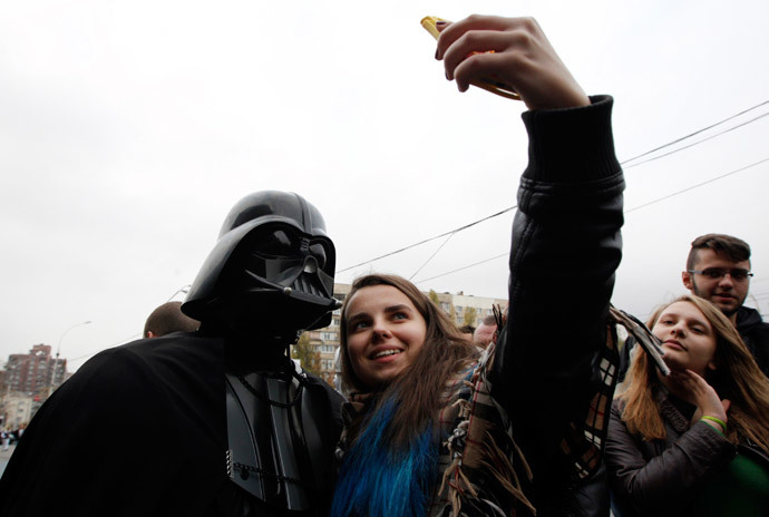 A candidate, presenting himself in the character of "Star Wars" villain Darth Vader and representing the Internet Party of Ukraine which runs for parliament, poses for a picture during a meeting with his supporters and voters in Kiev, October 22, 2014.(Reuters / Valentyn Ogirenko )