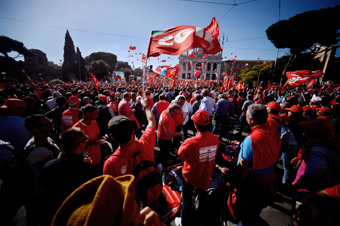 Italian General Confederation of Labour union (CGIL) workers gather for a rally in central Rome's San Giovanni Square on October 25, 2014 as part of a nationwide demonstration called to protest Prime Minister Matteo Renzi's plans to overhaul the labour market.(AFP Photo / Filippo Monteforte)